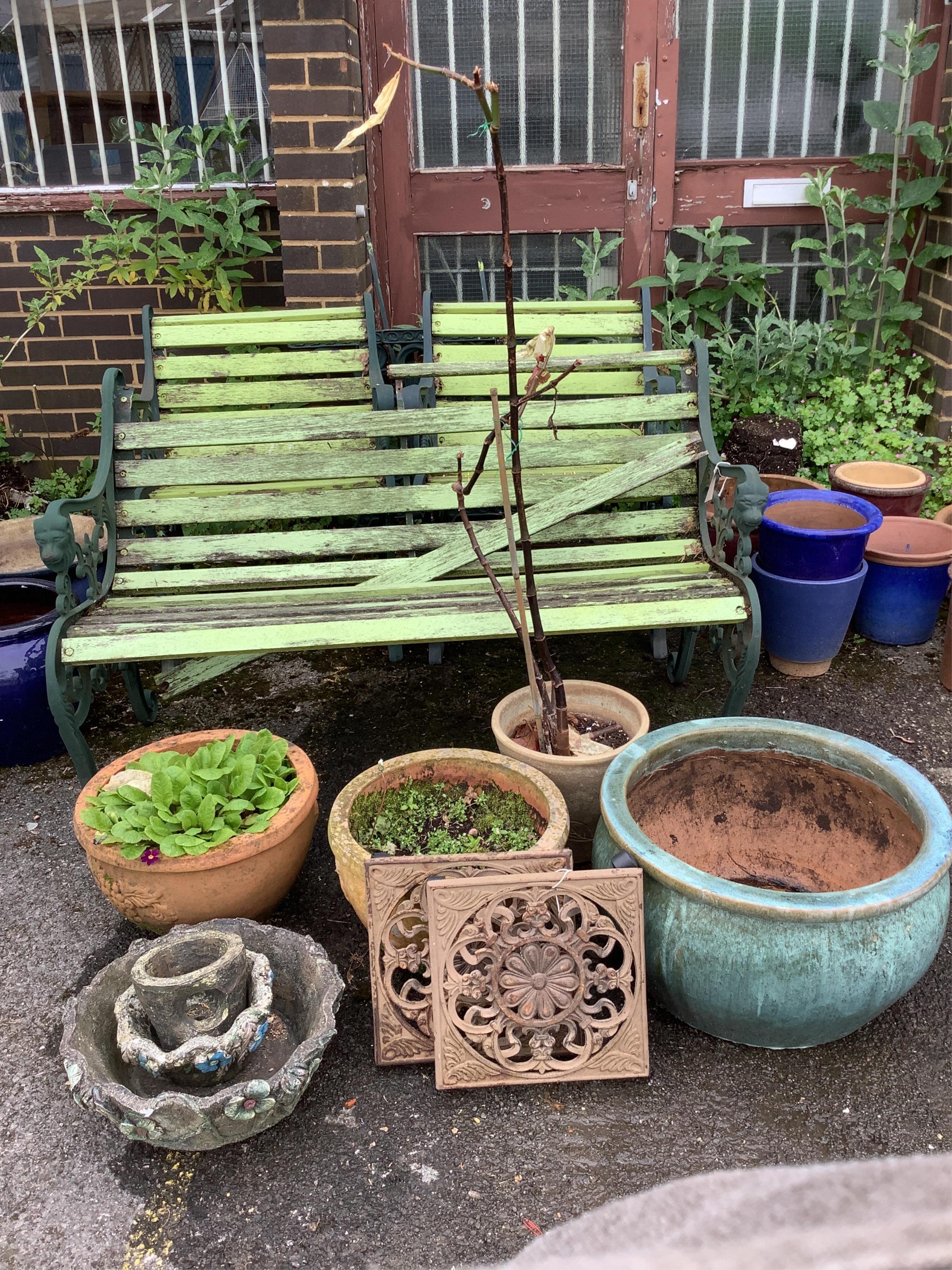 Seven assorted stone and earthenware garden planters, largest diameter 52cm, height 30cm, together with a pair of metal wheeled pot stands